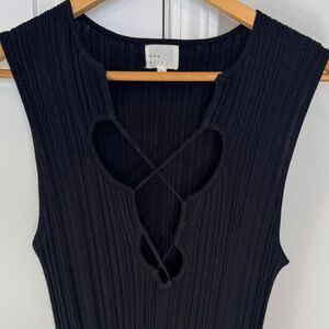 Dee Elly Black Sleeveless Knit Dress with slit to the knee on both sides.
